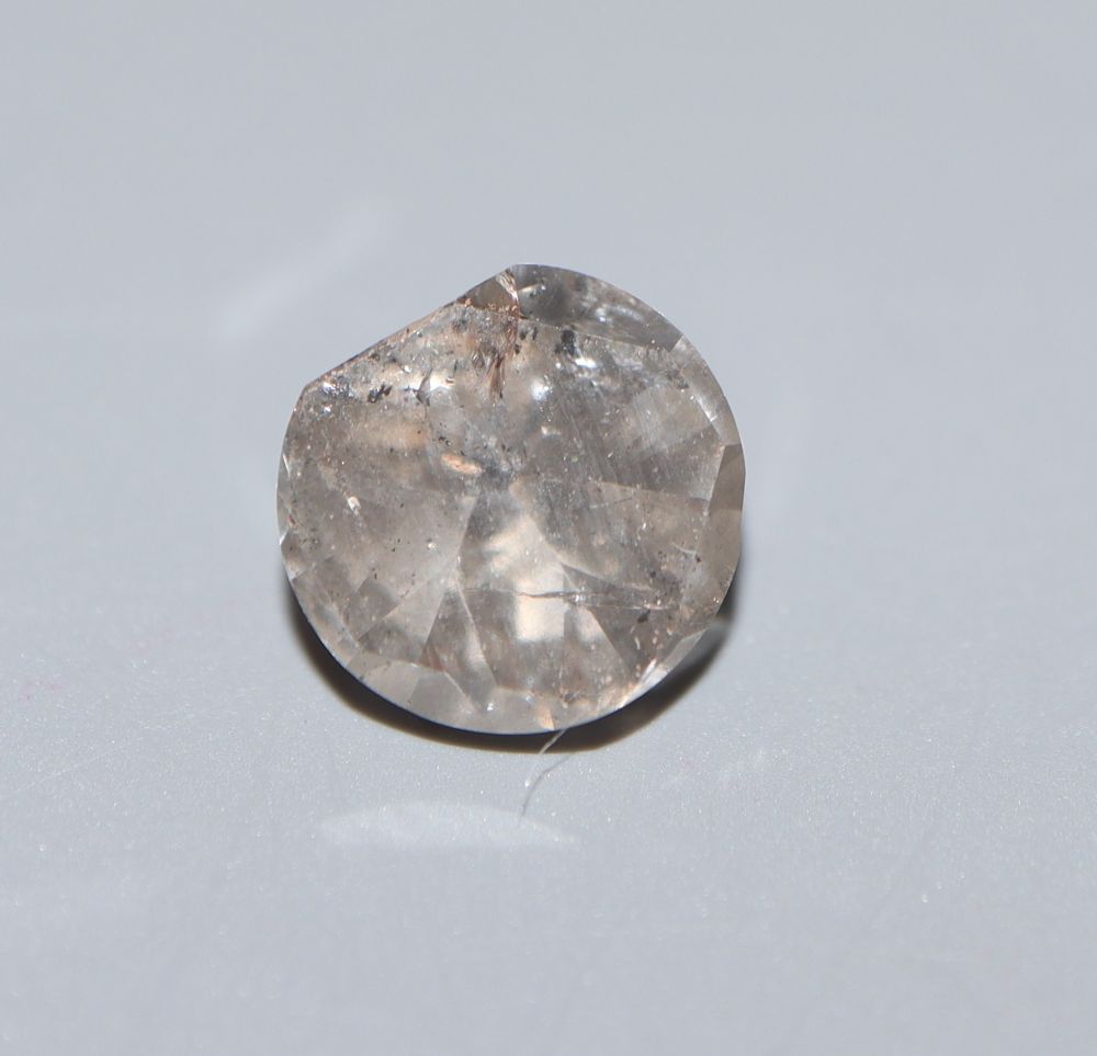 An unmounted flat? cut diamond, weighing approximately 1.52ct.